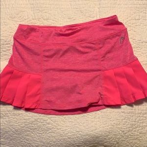 A neon pink tennis skirt with fringing